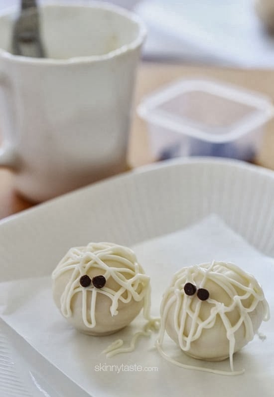 Easy Skinny Halloween mummy cake balls made light by using a box cake mix, egg whites and fat free Greek yogurt – no butter required!