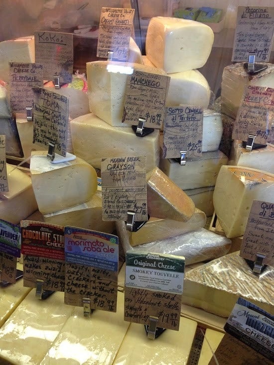 A collection of cheese wedges with labels and prices