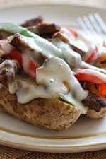 Quick skillet steak with onions, peppers, mushrooms loaded on top of a baked potato and topped with melted cheese – this loaded Philly cheesesteak baked potato is perfect for the meat and potato lover in your life!