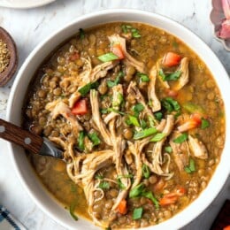 Bowl of chicken lentil soup with cilantro.