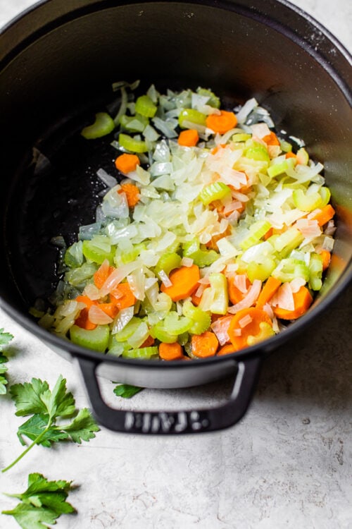 carrots, celery and onions in a pot.