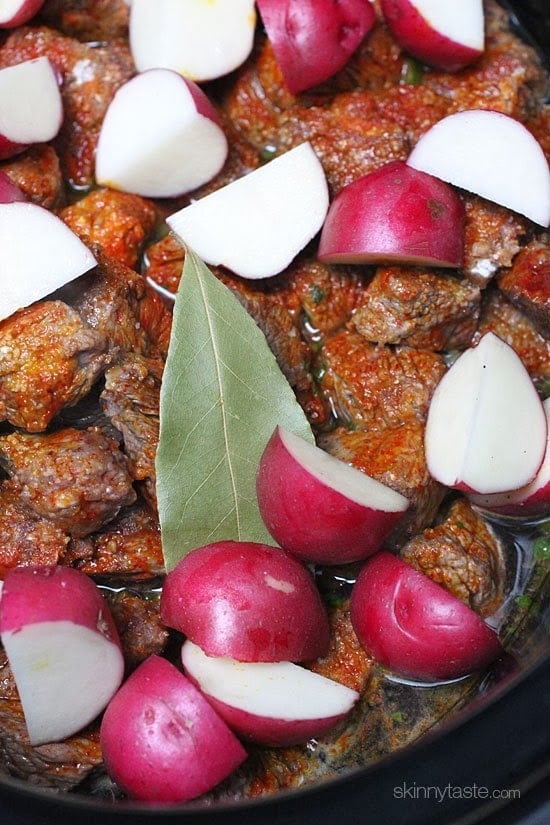 Crock pot carne guisada is a slow cooked Latin beef stew with baby red potatoes and Latin seasonings. Serve this topped with fresh aji picante – it's a must and really brightens the flavors and rounds out the dish!