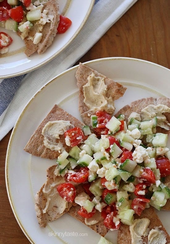 A lighter, healthier Greek twist on traditional nachos – made with whole wheat pita chips, hummus, cucumbers, tomatoes and feta.
