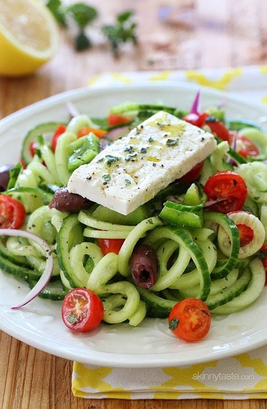 Spiralized Greek Cucumber Salad with Lemon and Feta is delicious, the perfect light dish. In Greece, Greek salads do not have lettuce, instead they are made with fresh cucumber, tomatoes, bell pepper, olives, red onion, oregano, lemon juice, olive oil, and fresh feta – delicious! 