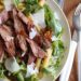 Grilled steak, arugula and pasta salad is topped with sweet balsamic caramelized onions and fresh shaved Parmesan. I'm a sucker for a good steak salad, and this one is AWESOME!