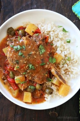 These slow cooker pork chops are seasoned with Latin spices in a flavorful sauce with tomatoes, olives, peppers and potatoes. They literally fall of the bone when they come out of the slow cooker!