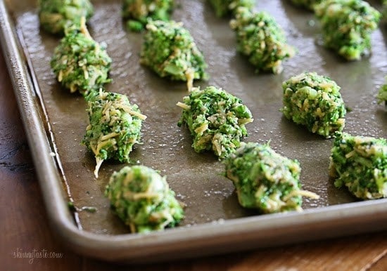 A baking sheet with uncooked broccoli and cheese tots