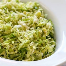 This raw shredded brussels sprouts salad is so simple to make, even a 4 year old can do it (with Mommy's help). Tossed with a little olive oil, lemon juice, salt and pepper, it makes a wonderful side dish to any meal, and my family loves it!
