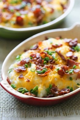 Creamy mashed cauliflower with cheese and bacon made with a touch of whipped butter, buttermilk, garlic and herbs and topped with cheese and bacon – low-carb, but you'll swear it's loaded with tons of calories!