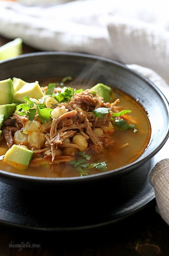 A bowl of instant pot pozole topped with cilantro and avocado