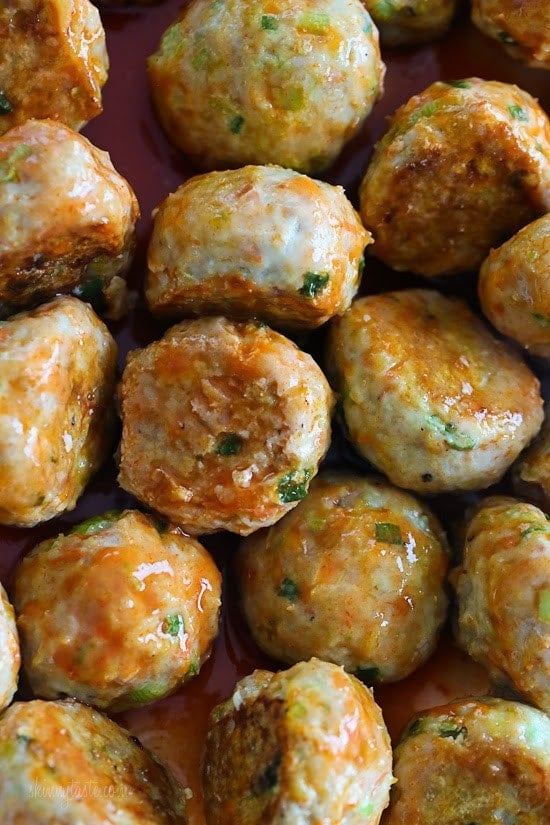 Buffalo Chicken Meatballs are perfect for football season! Made with minced celery and carrots hidden inside, topped with hot sauce, and homemade blue cheese dressing – yum!