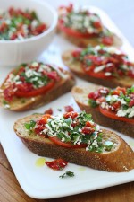 Super easy two tomato bruschetta made with roma and sun dried tomatoes, basil and feta cheese over toasted whole wheat bread.