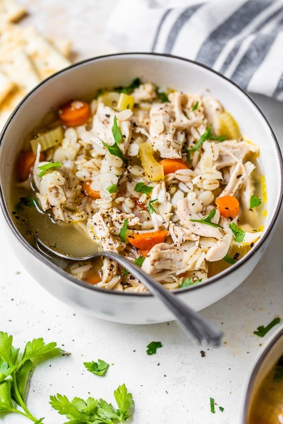 Chicken Barley Soup in a bowl with spoon.