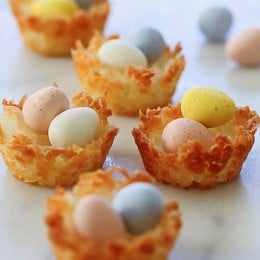 Easy gluten free coconut macaroons shaped like a bird's nest, filled with mini chocolate Cadbury eggs – a tasty Easter treat!