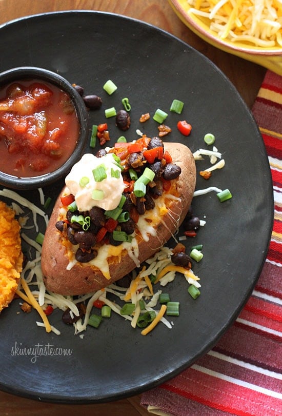 Loaded Vegetarian Baked Sweet Potato are Mexican-inspired, loaded with zesty black beans, melted cheese, salsa with a dollop of cream. What can be better than a 20 minute meal!