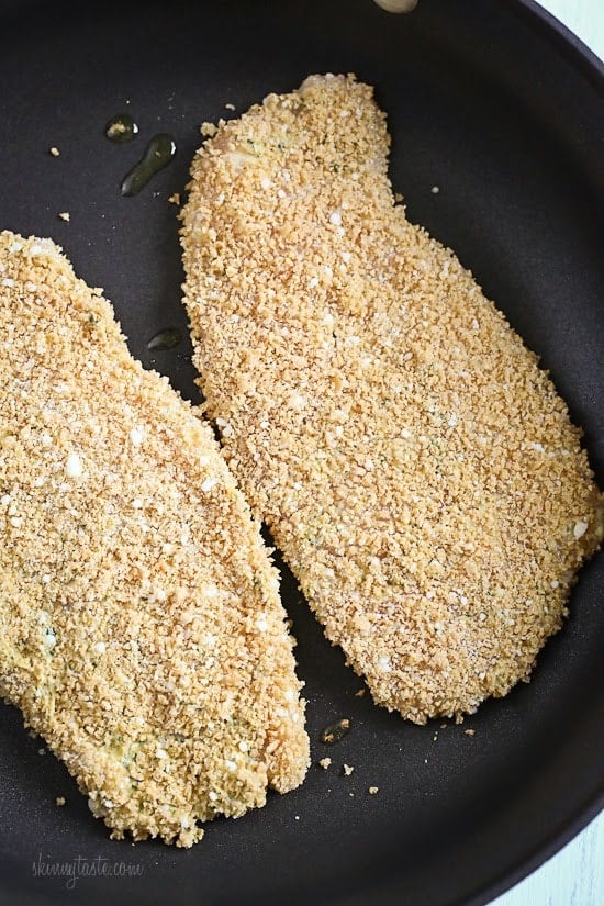 Mustard Herb Crusted Chicken Breasts cooking on a pan.