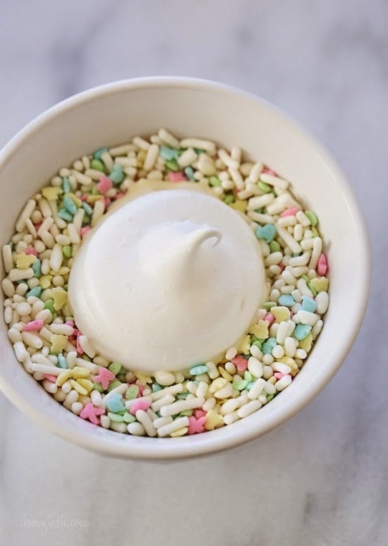 Sprinkle Dipped Meringues – Melt-in-your-mouth meringues dipped in white chocolate and sprinkles!