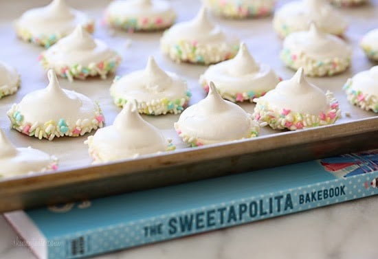 Sprinkle Dipped Meringues – Melt-in-your-mouth meringues dipped in white chocolate and sprinkles!