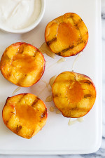 Nothing says summer like biting into a juicy peach. Grilling them is a simple way to enjoy them as a dessert, a perfect ending to a backyard BBQ without heating up your kitchen. Delicious topped with yogurt and honey, but also great topped with low fat ice cream. 