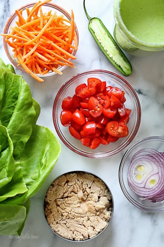 This low-calorie, low-carb tuna lettuce wrap with avocado yogurt dressing transforms ordinary canned tuna into a tasty light lunch filled with hearts of palm, tomatoes, carrots and onion.