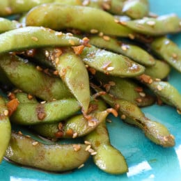 Asian Spicy Garlic Edamame is a flavor explosion in your mouth! An easy, totally addicting snack or side dish!