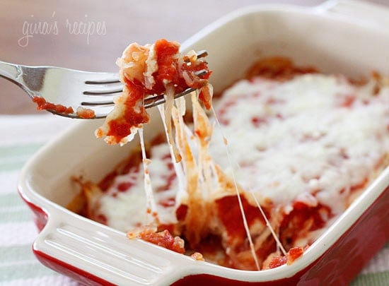 A casserole dish with layered spaghetti squash, marinara sauce, and melted cheese.