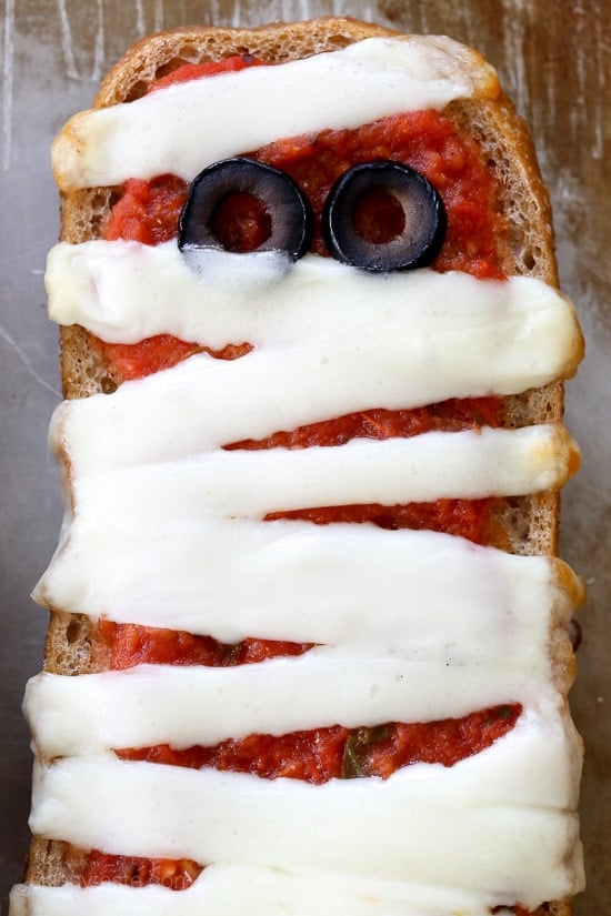 These EASY French bread pizzas are perfect for your next Halloween party, for kids or adults! Just 4 ingredients and about 15 minutes to make!