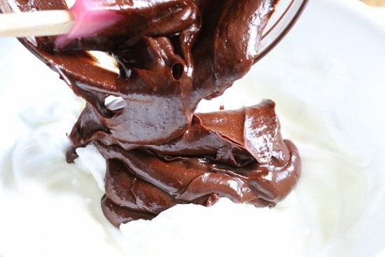 Chocolate cake batter being folded into whipped egg whites