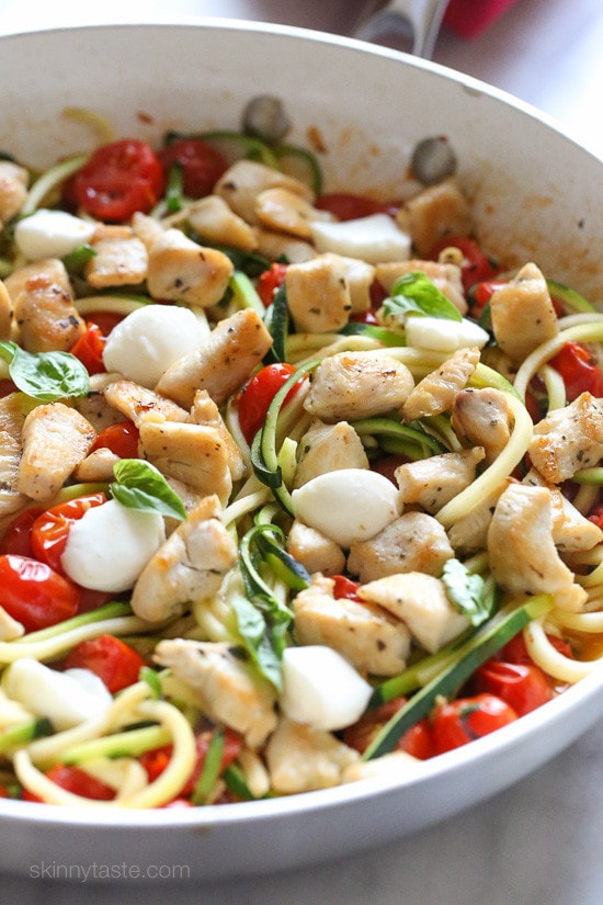 Chicken and Zucchini Noodle Caprese is made with sauteed bite-sized chicken breast and grape tomatoes cooked with spiralized zucchini, fresh mozzarella and basil. An easy, low-carb 30-minute meal!