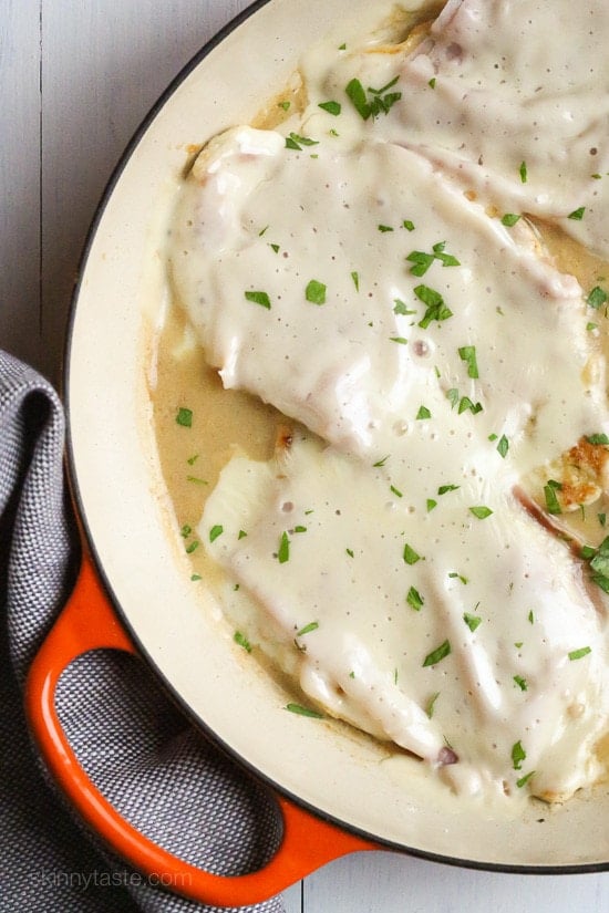 This EASY Skillet Chicken Cordon Bleu is made with thin sliced boneless chicken cutlets, lightly pan fried then topped with ham and swiss in a light Lemon-Dijon Sauce. No rolling!