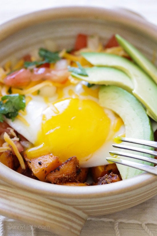 A Mexican-inspired breakfast burrito bowl with roasted butternut squash, pico de gallo, egg and sliced avocado. 