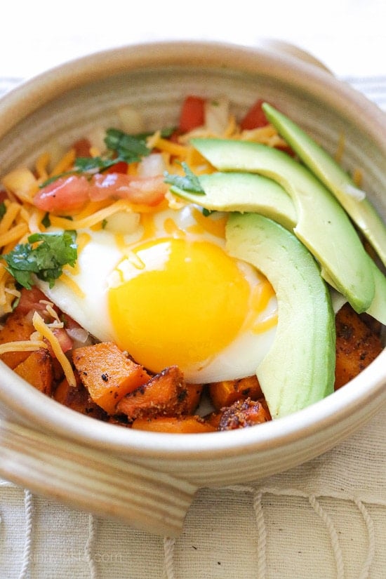 A Mexican-inspired breakfast burrito bowl with roasted butternut squash, pico de gallo, egg and sliced avocado. 