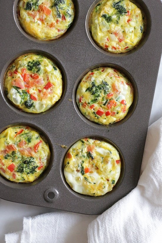 These easy, mini baked omelets with bacon, spinach, cheese and veggies are made in muffin tins, perfect to make ahead for the week.