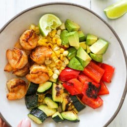 Grilled shrimp, corn, peppers and zucchini topped with fresh avocado and lime juice – an easy light salad you'll want to make all summer long.
