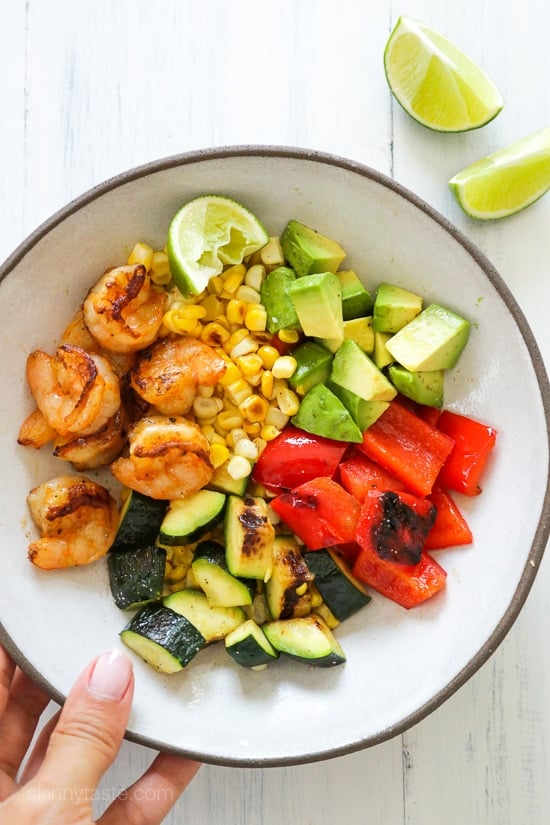 Grilled shrimp, corn, peppers and zucchini topped with fresh avocado and lime juice – an easy light salad you'll want to make all summer long.