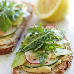 This simple vegan hummus-avocado toast is perfect for breakfast or lunch! Multigrain toast topped with good-for-you toppings ready in under 5 minutes, what could be better!