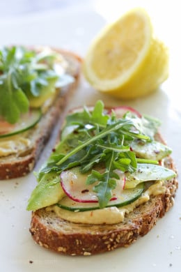 This simple vegan hummus-avocado toast is perfect for breakfast or lunch! Multigrain toast topped with good-for-you toppings ready in under 5 minutes, what could be better!
