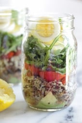 A protein-packed meatless salad in a jar made with quinoa, lentils, grape tomatoes, arugula, avocado and hard boiled eggs are perfect to pack for work, the beach, picnics, or anywhere you need a portable lunch on-the-go!