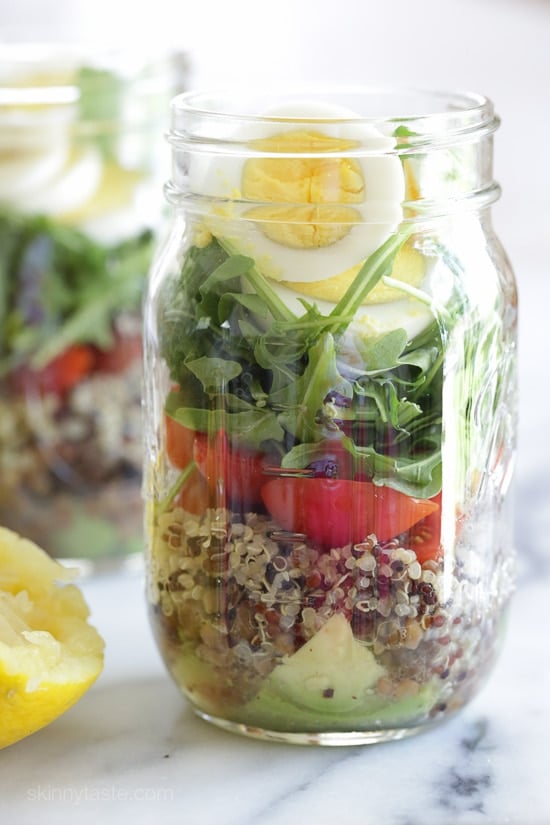 A protein-packed meatless salad in a jar made with quinoa, lentils, arugula, avocado and hard boiled eggs are perfect to pack for work, the beach, picnics, or anywhere you need a portable lunch on the go.