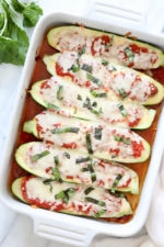 These low-carb Veggie Lasagna Zucchini Boats are basically hollowed out zucchinis stuffed with a veggie lasagna filling and baked in the oven with marinara sauce and melted cheese – SO GOOD!