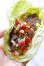 Grilled sirloin steak "flaco" tacos use lettuce wraps instead of tortillas! The steak is seasoned with cumin and spices, then grilled and sliced thin, along with guacamole and pico de gallo – low-carb and super delicious!