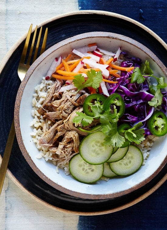 If you’ve ever had the classic Vietnamese Banh Mi sandwich, you probably know the bread can easily overpower the pork, pickled carrots and all the wonderful flavors, so I scrapped the bread and put all the goodies in a bowl over brown rice (it’s great over any grain) in my slim remake which is easy to make any night of the week!