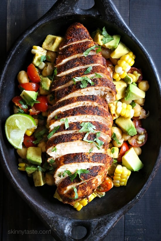 Blackened Chicken over a flavorful chickpea salad with fresh corn, tomatoes, avocado and lime juice. A quick and easy weeknight dish!