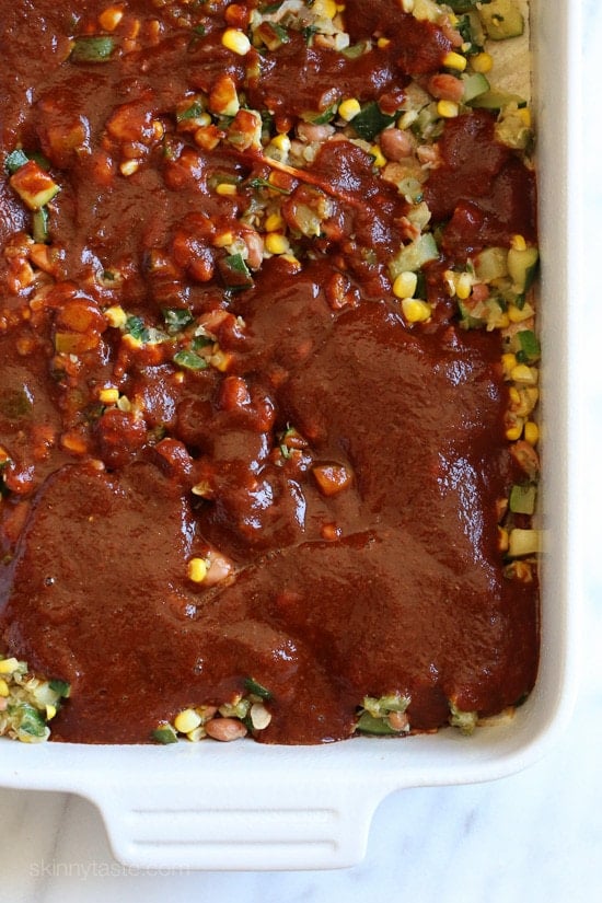 Assembling Late Summer Vegetable Enchilada Casserole