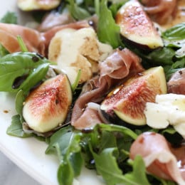 Figs and Prosciutto, savory and sweet they're a match made in heaven! Add some fresh mozzarella, peppery arugula and balsamic dressing and this salad will make you swoon with every bite.