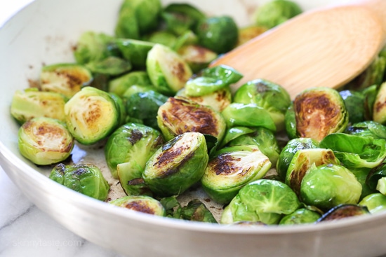 These Brussels sprouts start in the skillet and finish in the oven for perfectly charred edges, then drizzled with buffalo hot sauce and crumbled blue cheese – SO good!!