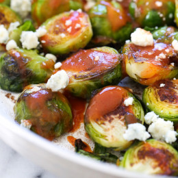These Brussels sprouts start in the skillet and finish in the oven for perfectly charred edges, then drizzled with buffalo hot sauce and crumbled blue cheese – SO good!!