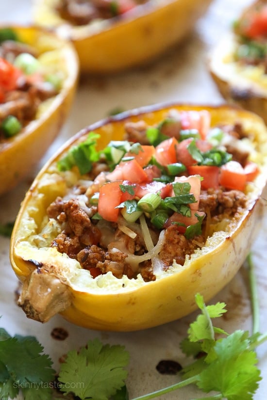These Turkey Taco Spaghetti Squash Boats are my favorite way to eat spaghetti squash! Filled with the most flavorful turkey taco meat, cheese and topped with pico de gallo. #lowcarb #keto #whole30 #glutenfree #spaghettisquash #spaghettisquashrecipe