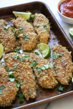 These baked chicken tenders are coated with seasoned crushed tortilla chips, baked until golden and served with salsa! An easy, weeknight chicken dish, great for the kids, or even adults.