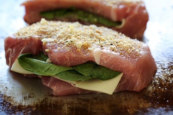 These stuffed pork chops are SO good, inspired my a meal I had a few nights ago at a local Italian restaurant. Stuffed with prosciutto, mozzarella and baby spinach then topped with garlic and breadcrumb. 